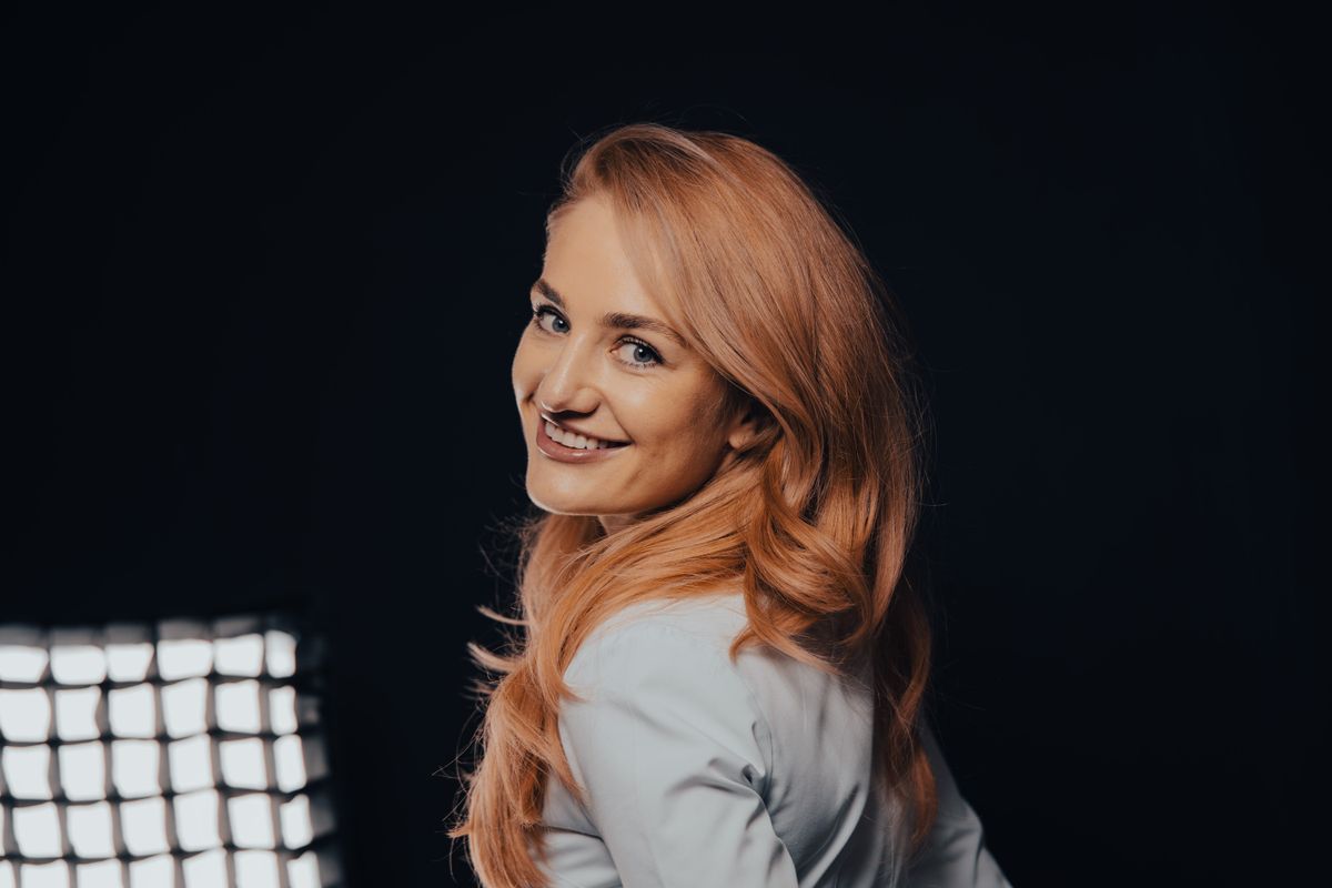 Confident young woman smiling, representing creator success.