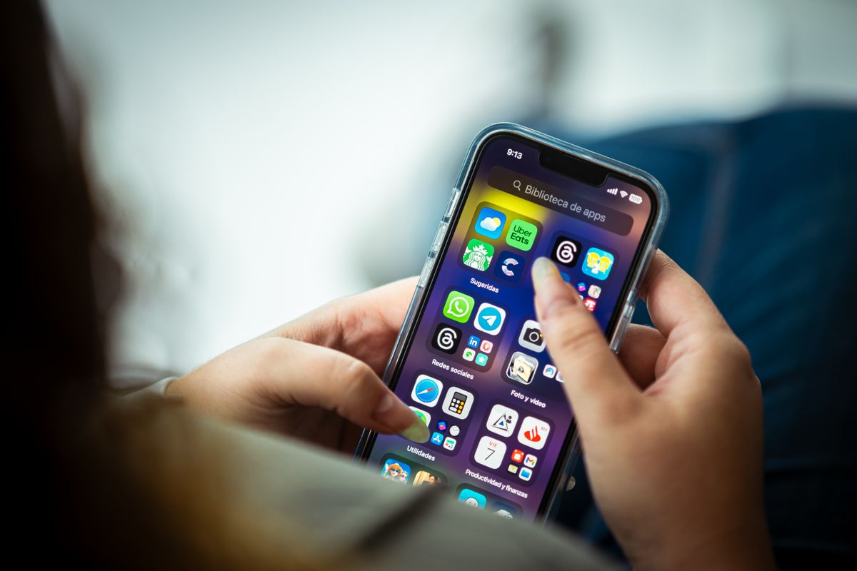 A phone showing a clean link-in-bio landing page with several buttons