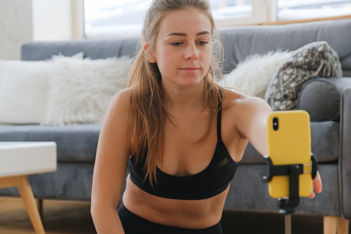 A creator filming a short video on a phone in a bright room